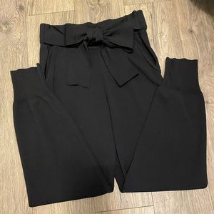 Lush black pants with beautiful bow front, pocket and jogger style pant end.